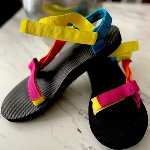 Multi-colored Tevas in women’s size 10.